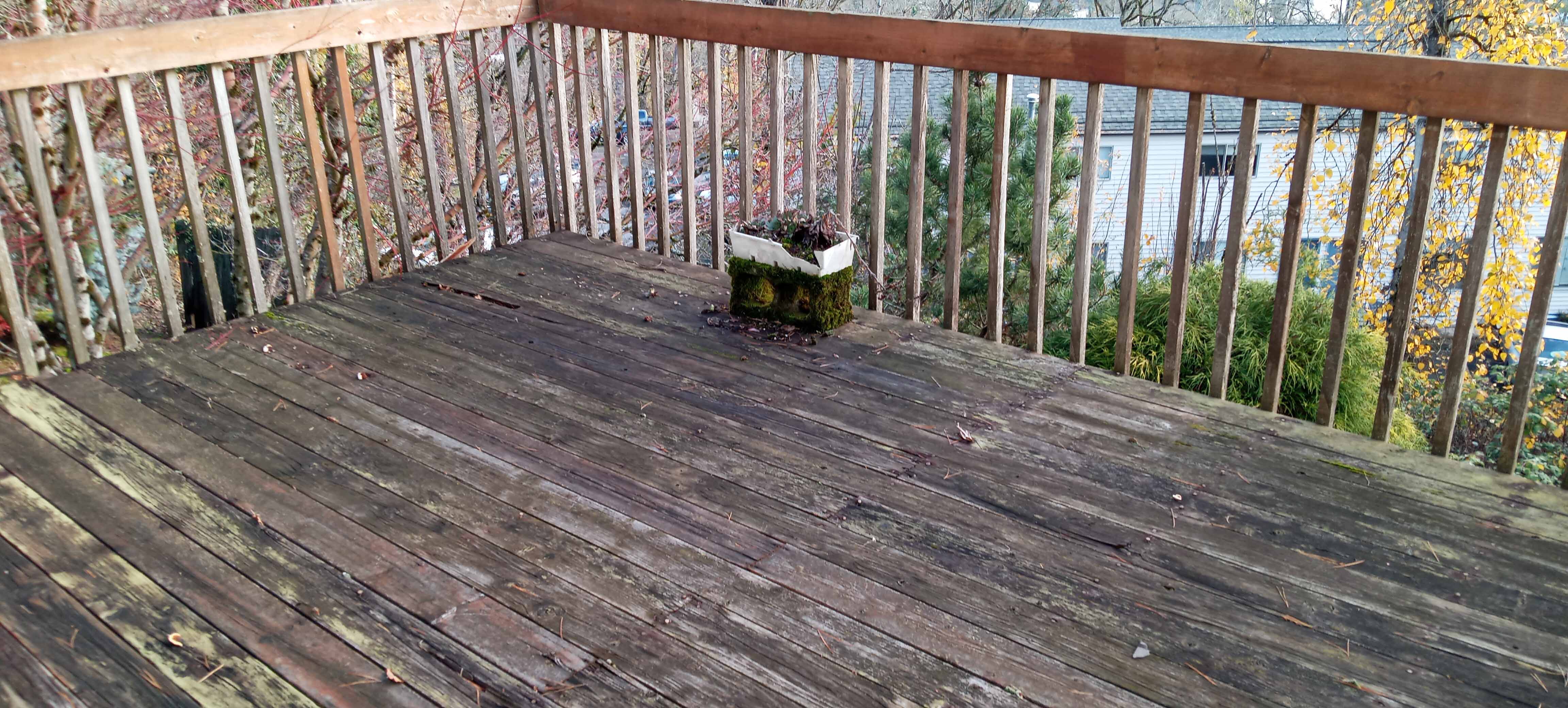 Old deck with rotting boards before remodel