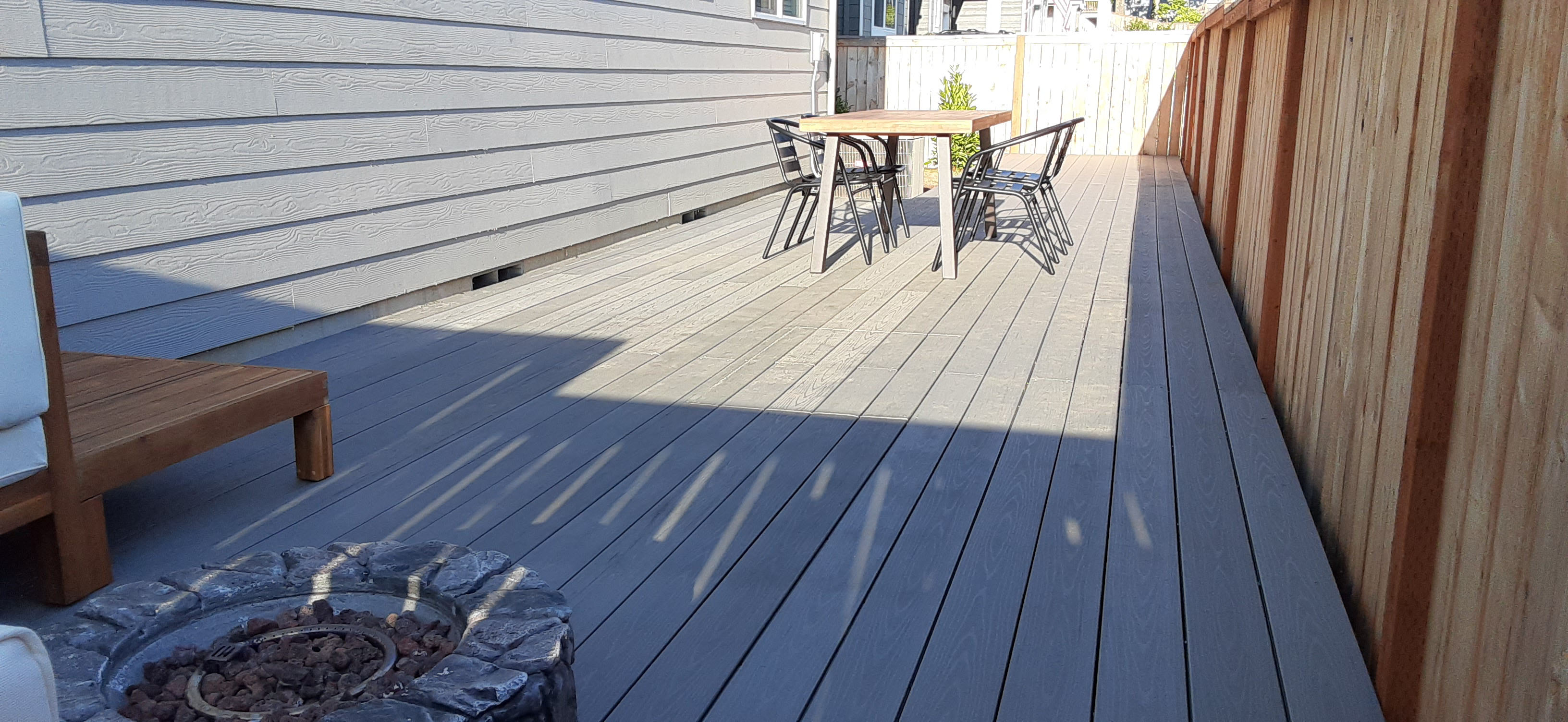 Remodel of plain backyard with full, custom built ground level wood deck