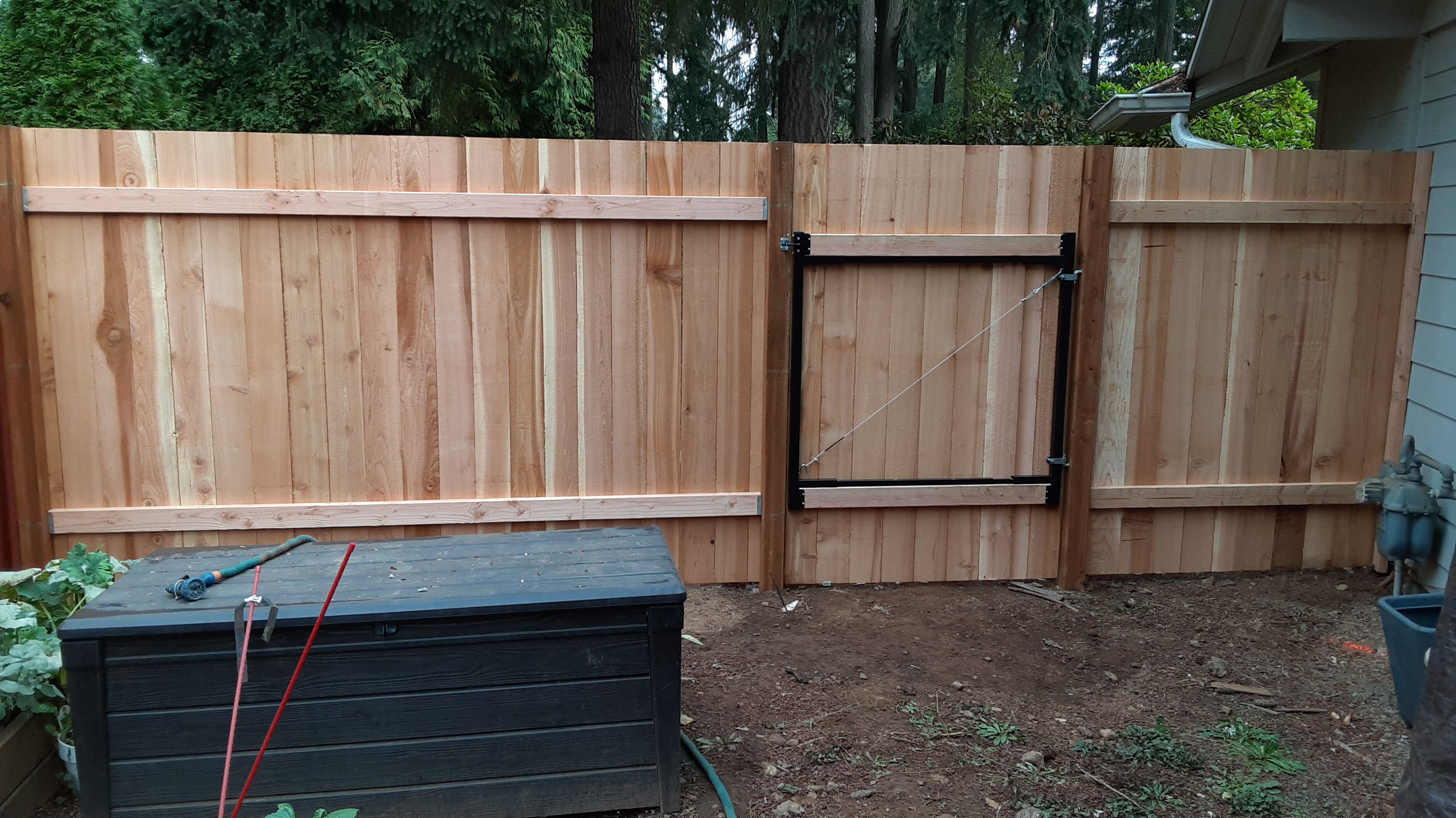 Remodeled wood fence with wood posts and new wood fence gate