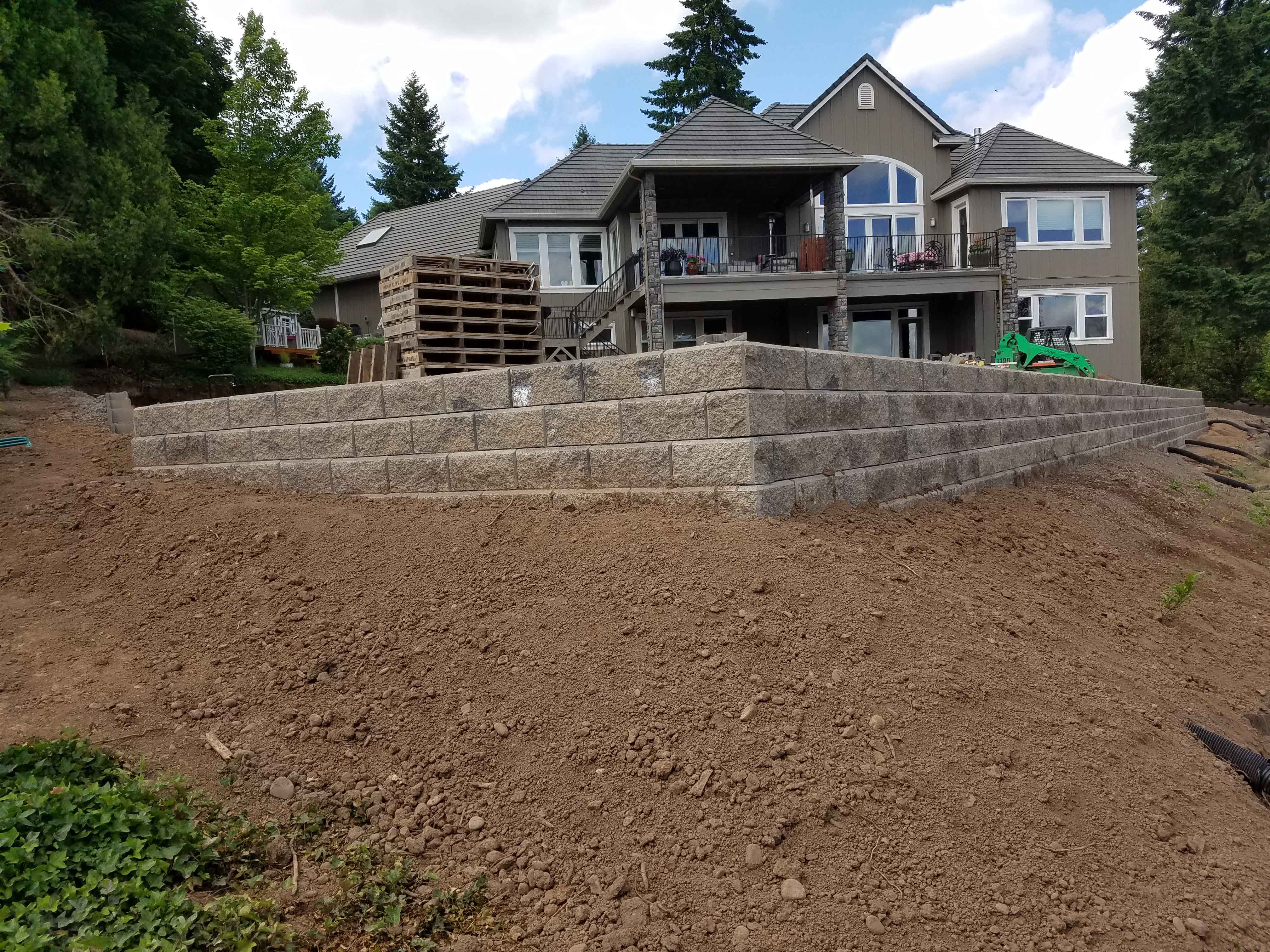 Finished backyard with retaining wall and properly laid dirt