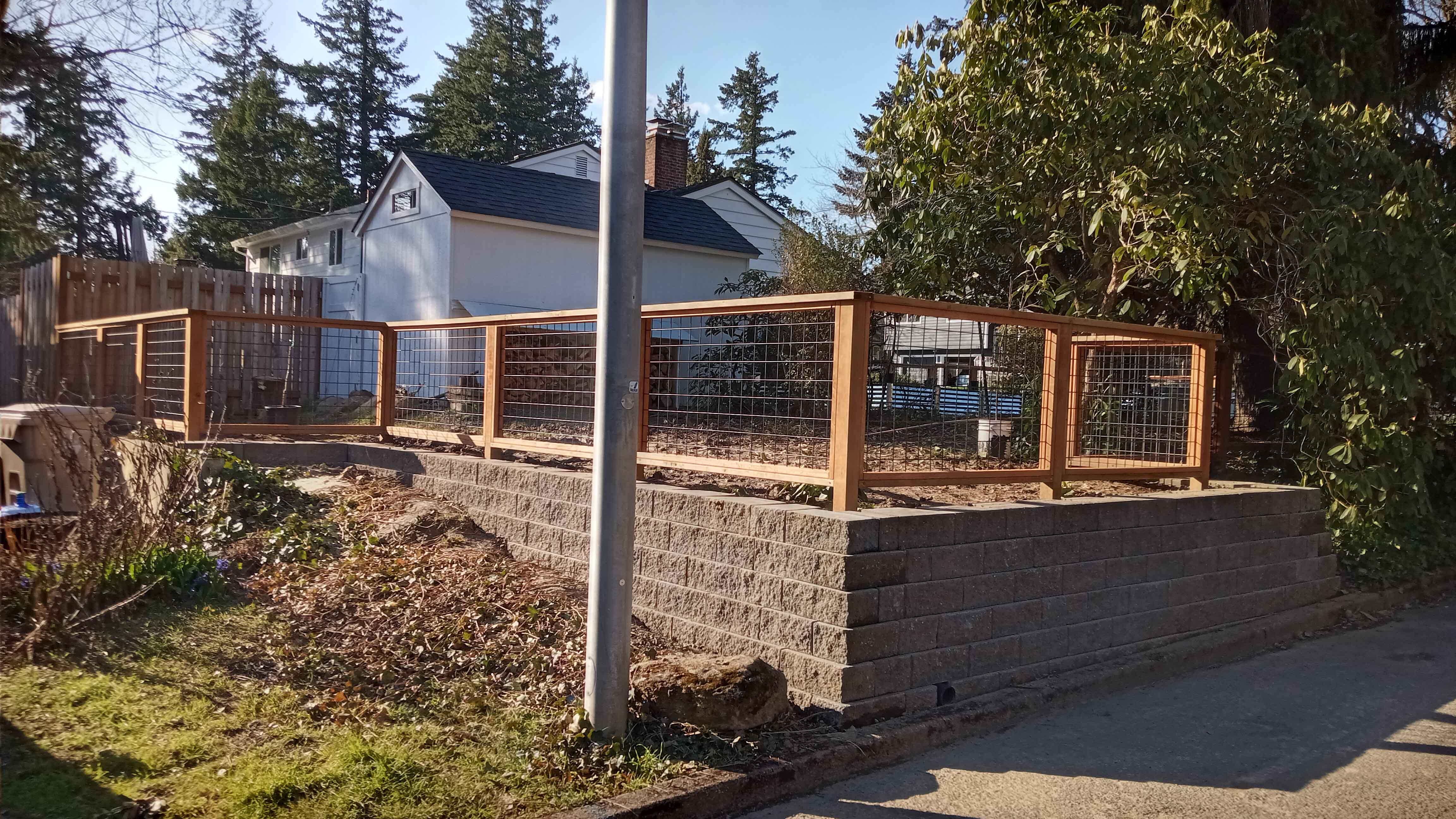 Brand new, custom built retaining wall with wood fence on top