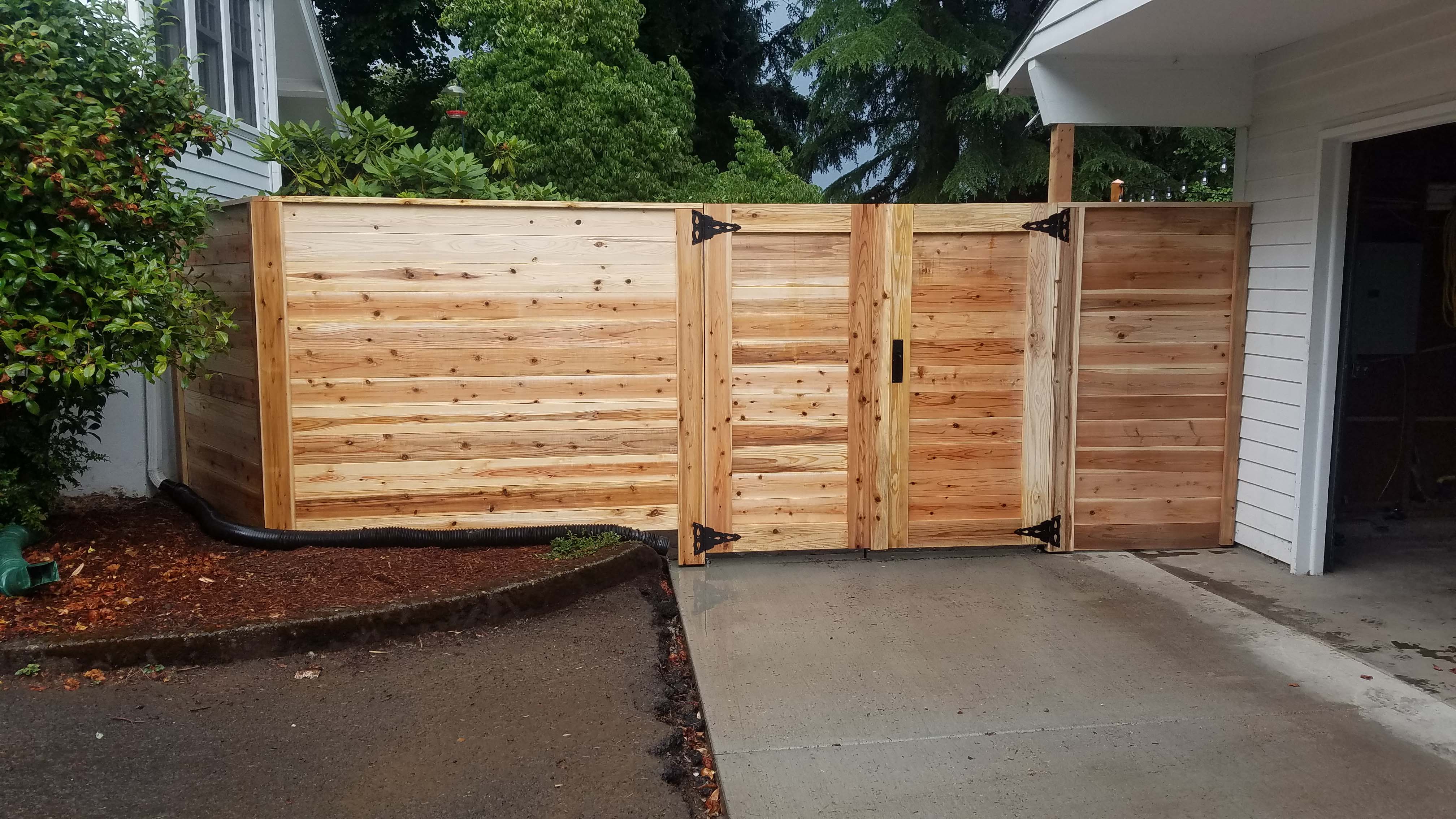 Brand new, custom built retaining wall with wood fence on top