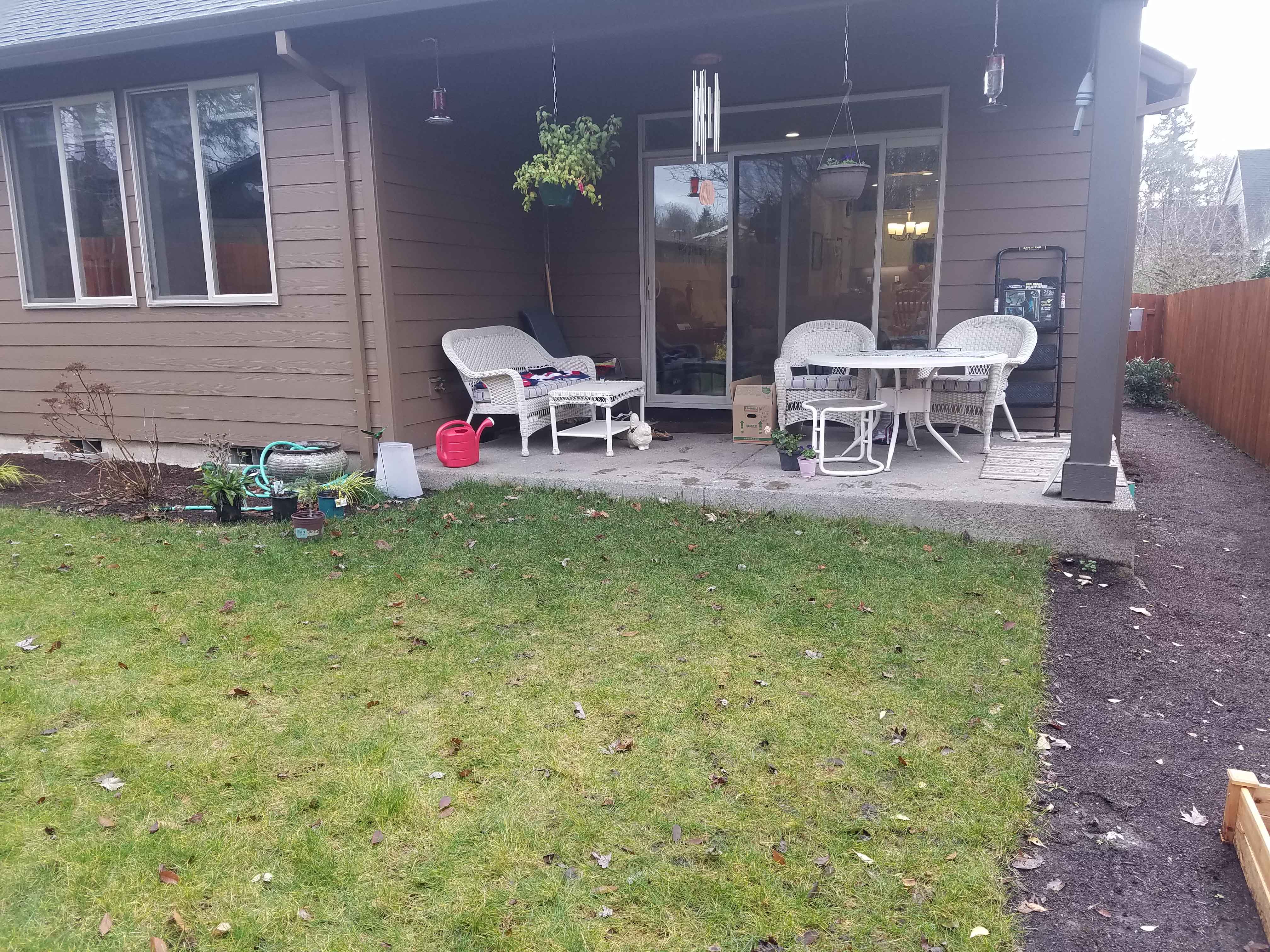 Small back covered patio with room for a few chairs and table